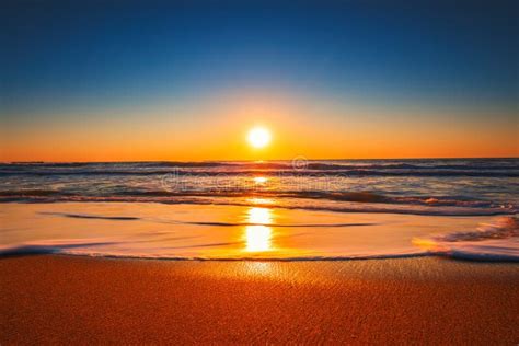 Beach Sunrise Or Sunset With Clear Blue Sky And Rising Sun Stock Image