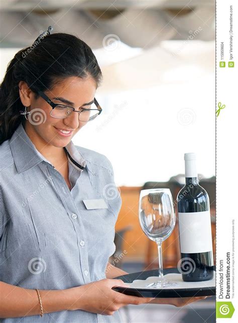 The Waitress Is Carrying A Bottle Of Wine Stock Photo Image Of