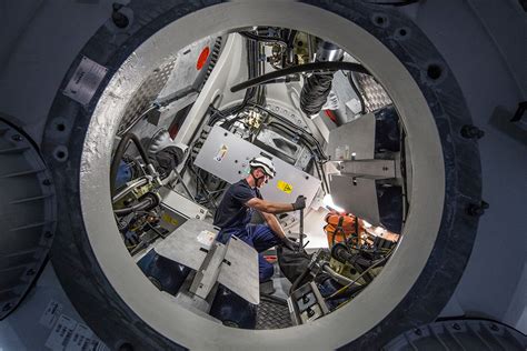 A wind turbine works the exact opposite of a household fan. worker-inside-wind-turbine-nacelle | WindEurope