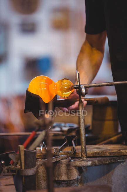 Mid Section Of Glassblower Forming And Shaping A Molten Glass At Glassblowing Factory — Shape