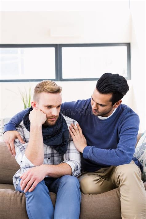 Gay Couple Comforting Each Other On The Couch Stock Photo Image Of
