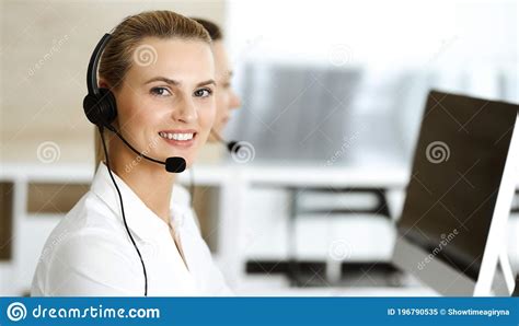 Blond Female Customer Service Representative And Her Colleague Are