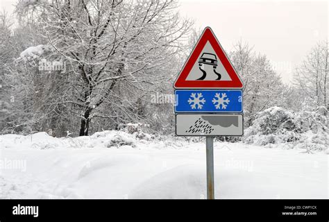 Slippery Road Sign In Snow Severe Weather Conditions Stock Photo Alamy