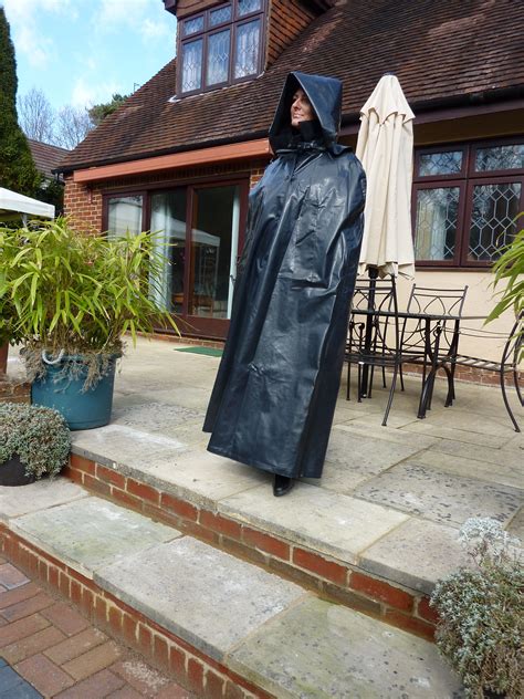 A Dramatic And Effective Waterproof Cape In Shiny Black Surfaced