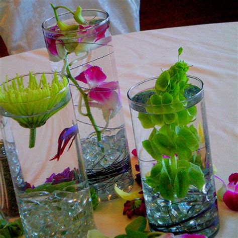 This picture shows the betta in a vase which consists of a large vase with some marbles in the bottom, a peace lily plant, and a betta fish. betta fish flower vase | Fish | Pinterest | Not enough ...