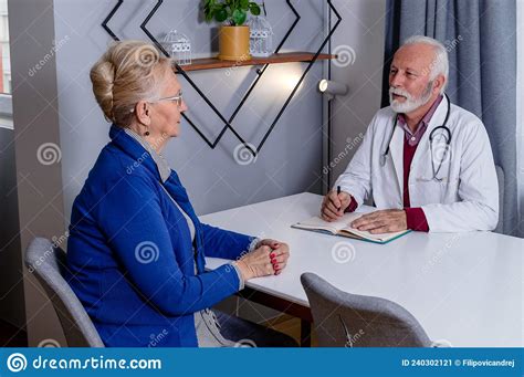Experienced Doctor Discussing With Senior Female Patient Her Private Medical File Stock Image