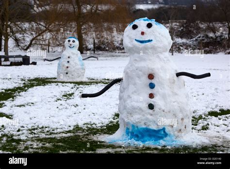Two Snowmen In Park Stock Photo Alamy