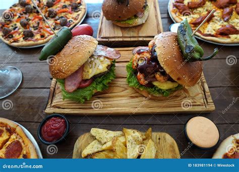 Closeup Shot Of Delicious Burgers On A Wooden Table Stock Photo Image