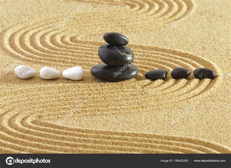 Japanese Zen Garden With Stacked Stones In Textured Sand Stock Photo By