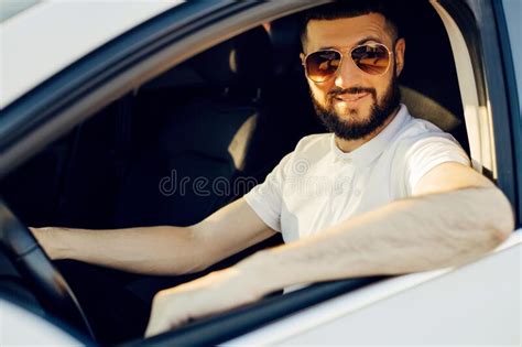 Front View Young Handsome Man Looking Straight While Driving A Car