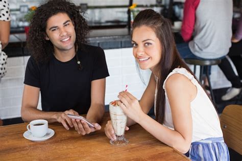 Premium Photo Portrait Of Lesbian Couple Smiling While Having A Cup Of Coffee