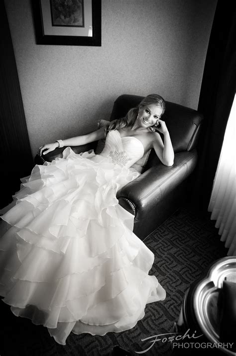 A Woman In A Wedding Dress Sitting On A Chair