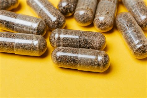 Capsules On Yellow Surface · Free Stock Photo