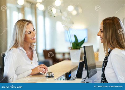 Receptionist And Businesswoman At Hotel Front Desk Stock Photo Image