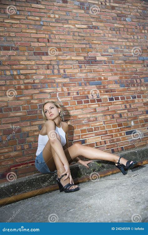 Woman Against Brick Wall Stock Image Image Of Wall Sitting 2424559