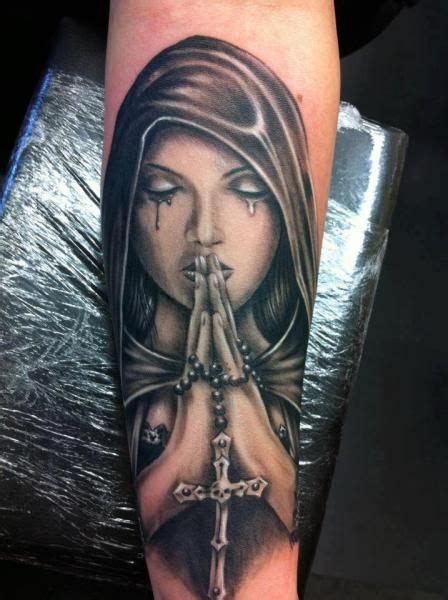 a woman with a cross on her arm is shown in this tattoo design by person