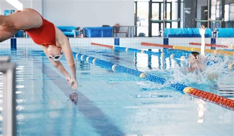 Sports Swimming Pool And Woman Diving In Water For Training Exercise