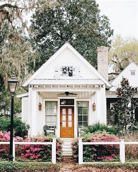 All White Home Surrounded By Lovely Flora Small Cottage Homes Small