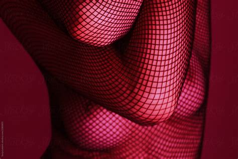 Female Torso In Net Fashion Erotic Outfit In Red Light By Stocksy