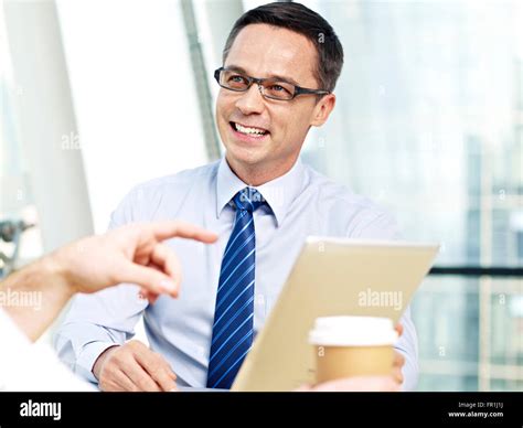 Business Man Holding Tablet Computer Listening To Someone And Smiling