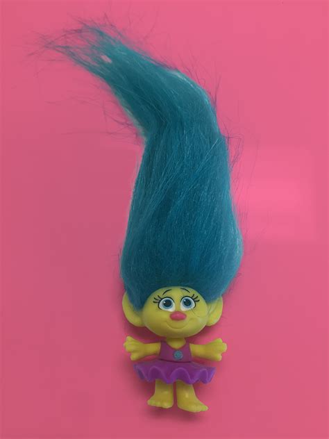 Her new hair is a wavy and a little frizzy with blue streaks and tips. 'Trolls' Dreamworks Movie Character Guide and Bios