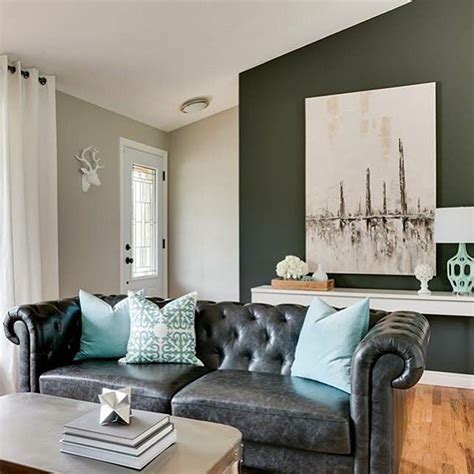 The matte black accent wall centers the living space, a suspended credenza and notice the contrast between the frosty view of the outdoors and the bright tropical theme of the interior. Black Leather Chesterfield Sofa with Turquoise Pillows ...