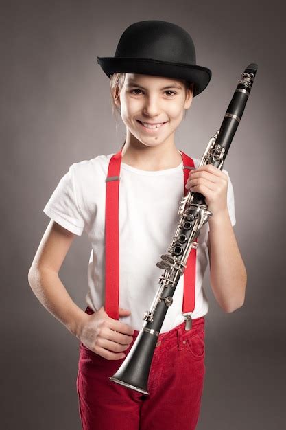 Premium Photo Little Girl Playing Clarinet On Gray