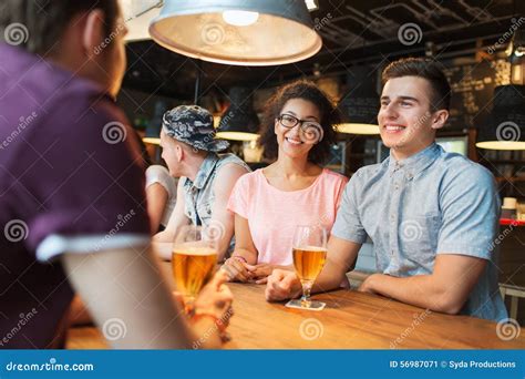 Happy Friends Drinking Beer And Talking At Bar Stock Image Image Of