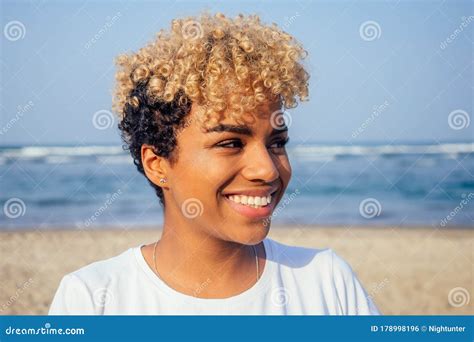 Latin Hispanic Woman With Perfect Skin And Curly Afro Hair Enjoying At