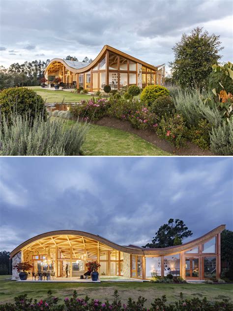 The Wavy Roof On This House Also Has An Exposed Wood Structure On The