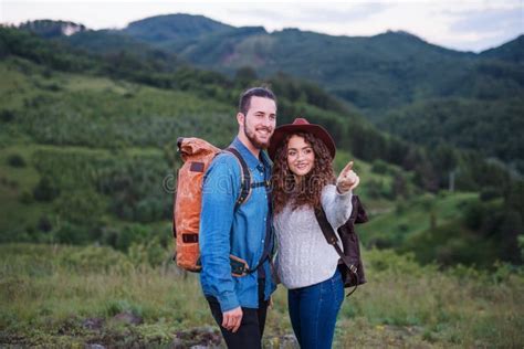 Young Tourist Couple Travellers With Backpacks Hiking In Nature