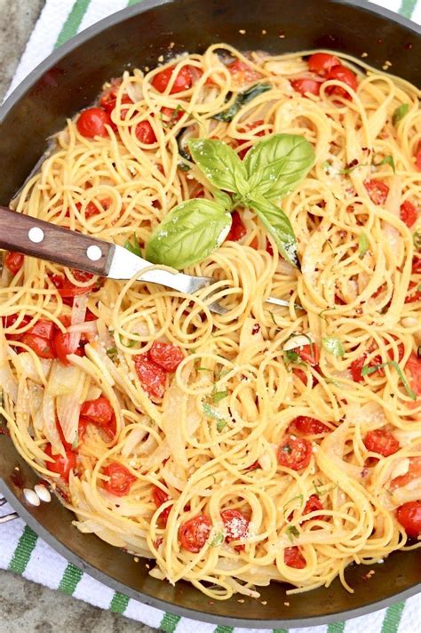 A Skillet Filled With Pasta And Tomatoes