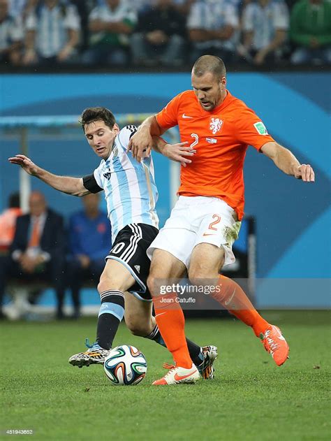 Lionel Messi Of Argentina And Ron Vlaar Of The Netherlands Challenge News Photo Getty Images