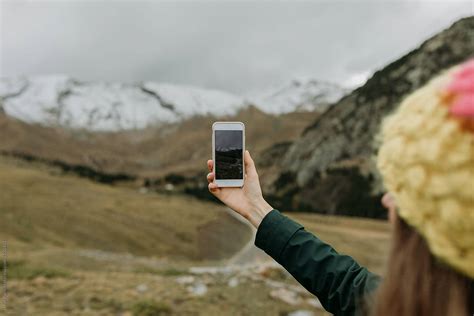 Woman With Smartphone Taking Photos At Nature By Stocksy Contributor