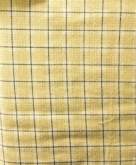 Light Yellow Plaid Flannel Fabric With Dark Stripe Running Through