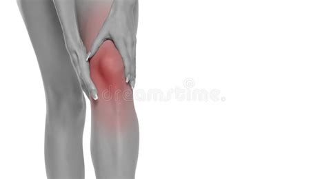 Woman Holding Her Painful Knee On White Studio Background Stock Image