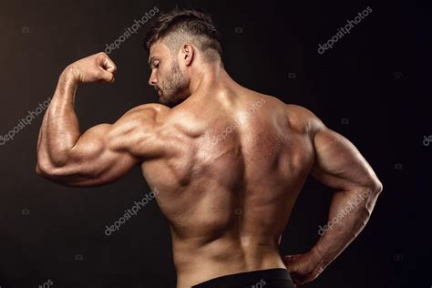 Learn how to draw the lower back muscles by learning their form. Strong Athletic Man Fitness Model posing back muscles, triceps, — Stock Photo © _italo_ #85706028