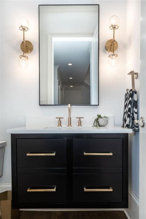 Hgtv Features A White Powder Room With A Black Vanity With Gold Toned