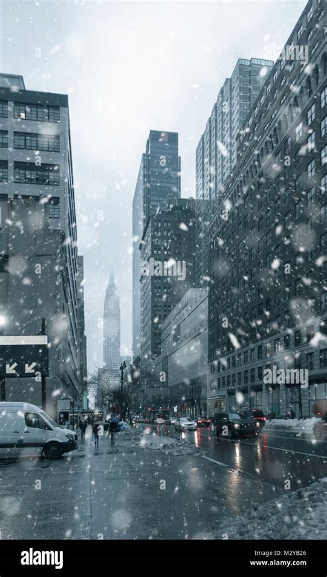 Falling Snow In New York City Skyline With Urban Skyscrapers In