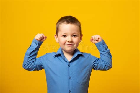Cute Little Boy Showing His Hand Biceps Muscles Strength Isolated On