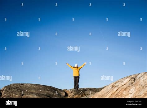 Woman Standing On Rocks Stock Photo Alamy