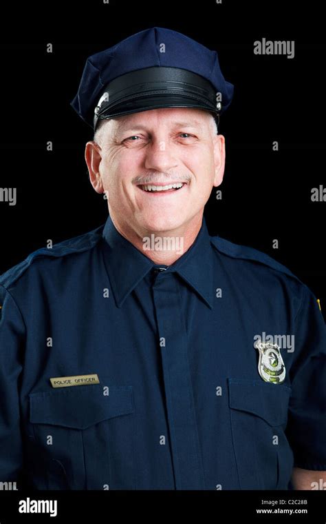 Portrait Of Friendly Smiling Police Officer On Black Background Stock