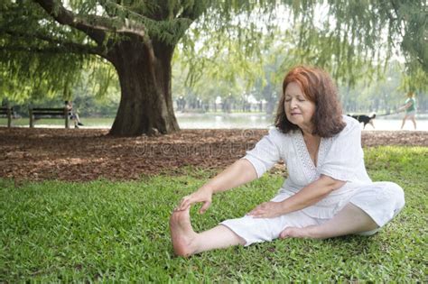 mature woman doing stretching exercises wellness active and healthy lifestyle stock image