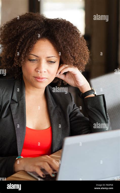 Mixed Race Businesswoman Working On Laptop Stock Photo Alamy