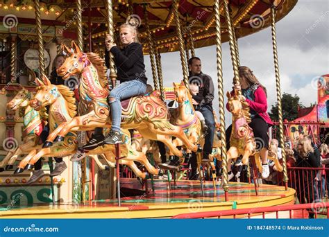 People Riding On Carousel Horse On Fairground Ride Editorial Stock
