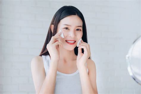 Young Beauty Asian Woman Cleaning Face With Cotton Clear Face Skincaremakeup Mirror And Smile