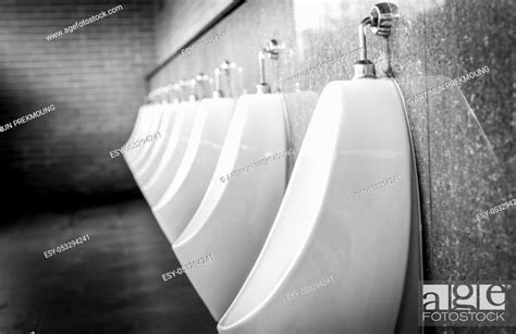 White Urinals In Men Public Toilet Urinals Made Of Ceramic In A Row In Gentleman Restroom