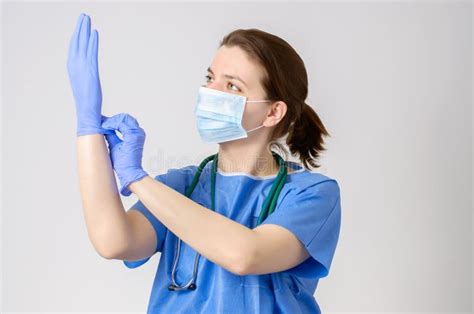 doctor putting on blue surgical gloves stock image image of blue doctor 54599057