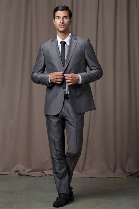 Maybe you would like to learn more about one of these? Grey, shiny suit with white shirt, skinny black tie and ...