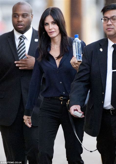 Courteney Cox In Navy Blouse With Cigarette Slim Trousers Daily Mail